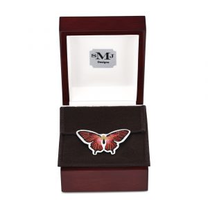 red butterfly necklace made with the cloisonné technique, shown up close in its box